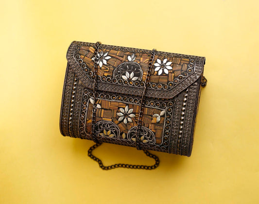 A floral handcrafted bag placed on a yellow background.
