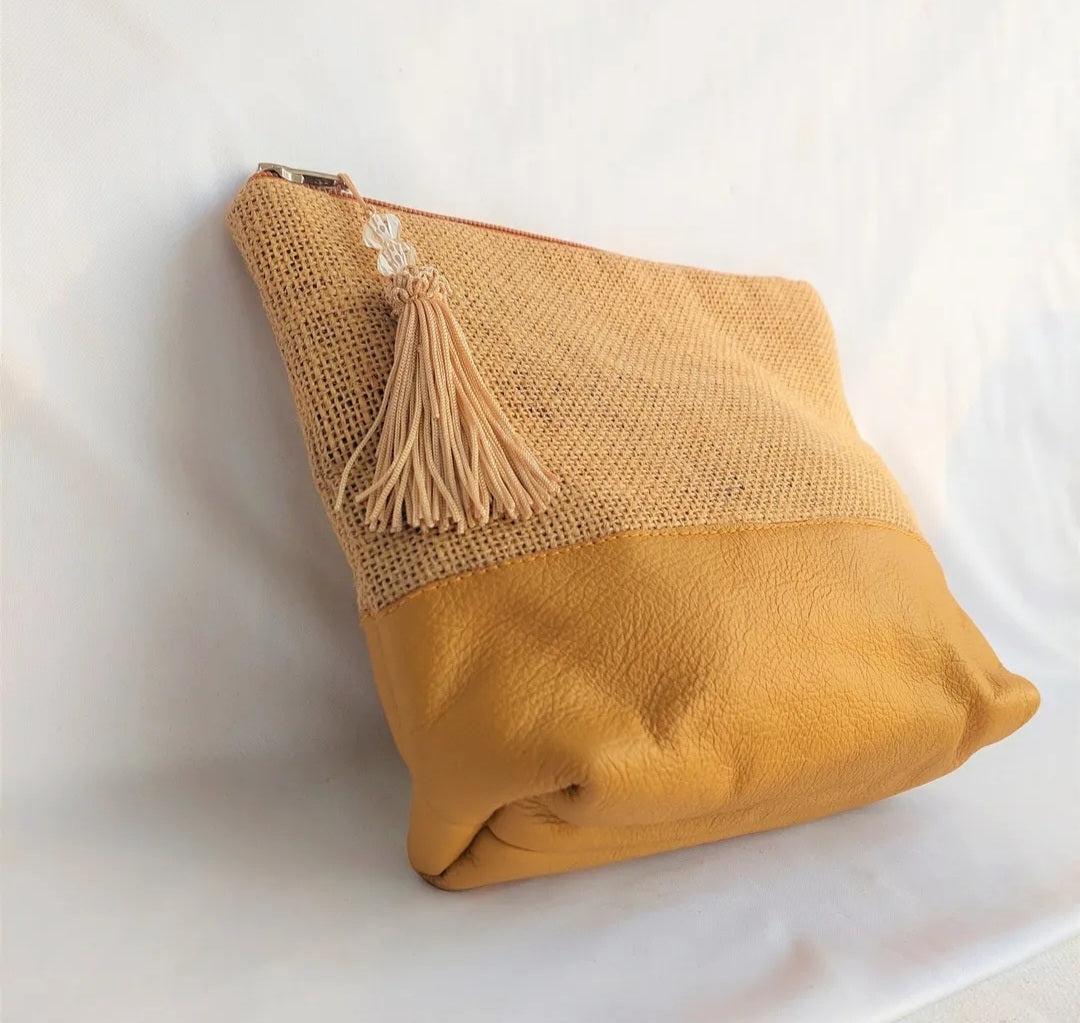 Beige handcrafted leather & hemp clutch bag with tassel from Bags By Uma.


