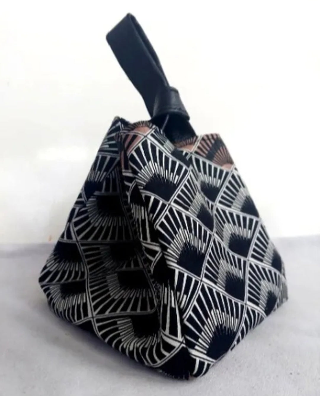 The Lita Knot Bag by Uma, a luxury handbag featuring a minimalist design with a unique knot detail on the handle.